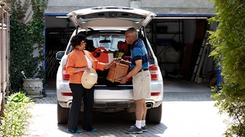 Man and Woman Packing SUV
