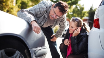 Man and Woman inspecting damage